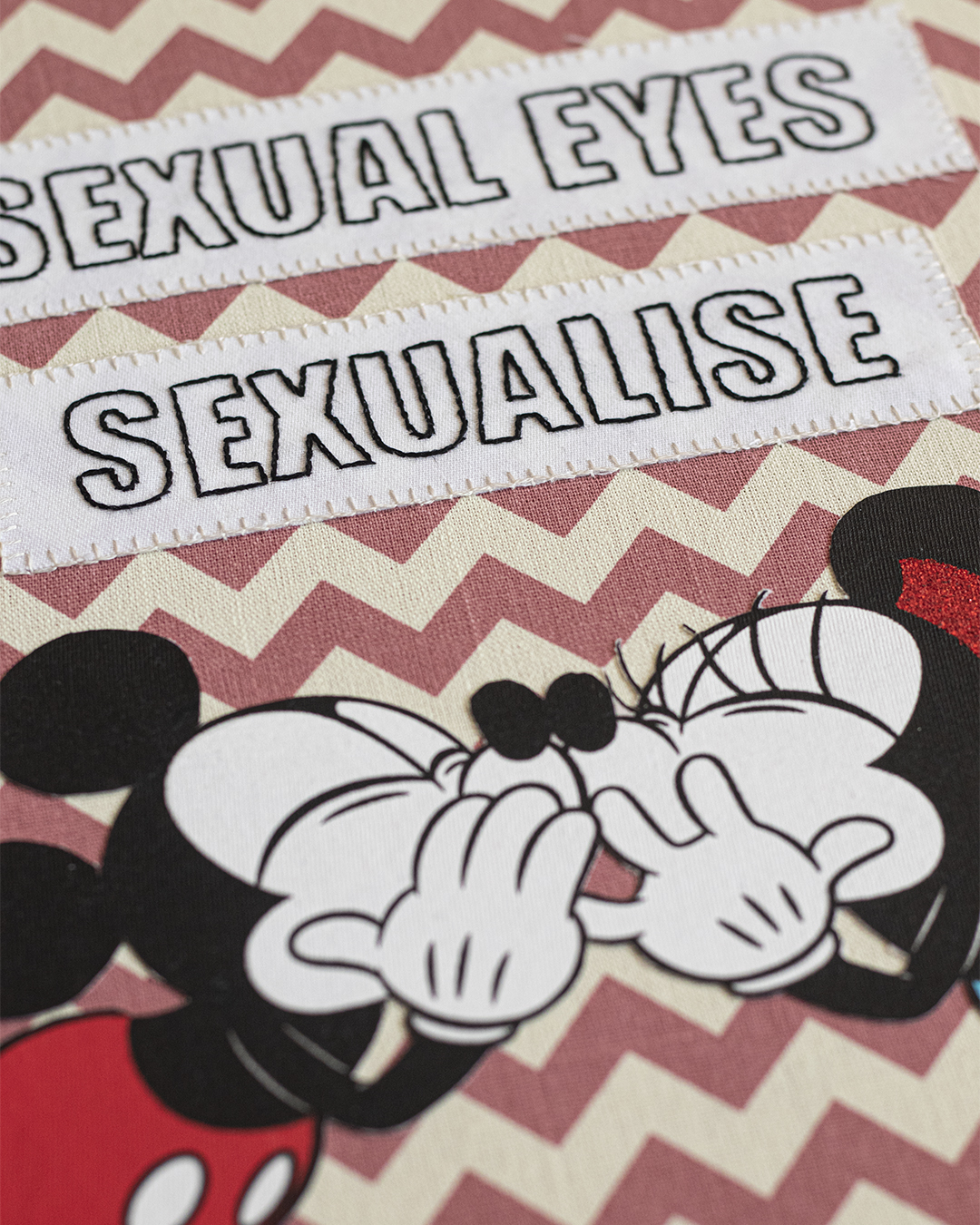 A close up of an ambroidered artwork called Sexual Eyes, Sexualise, Sexual Lies